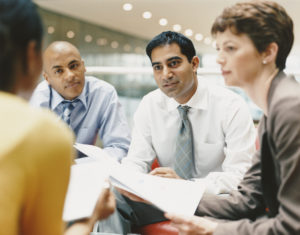 Business People Sitting in an Office Building Chatting