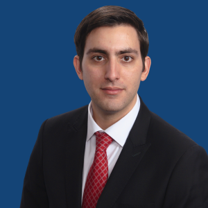 headshot of Oliver Nodjoumi in a suit and tie