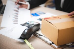 Business Transactions with Terminal and Cardboard Box